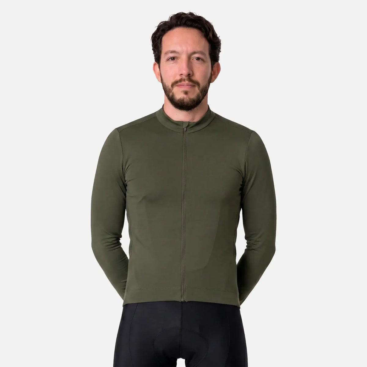 Man wearing olive green cycling jersey with full zip and black padded shorts