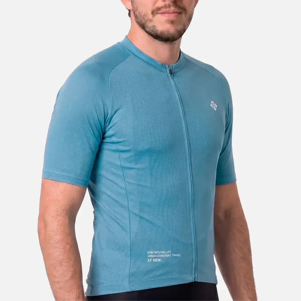Men's teal cycling jersey with zip front and text details for urban travel