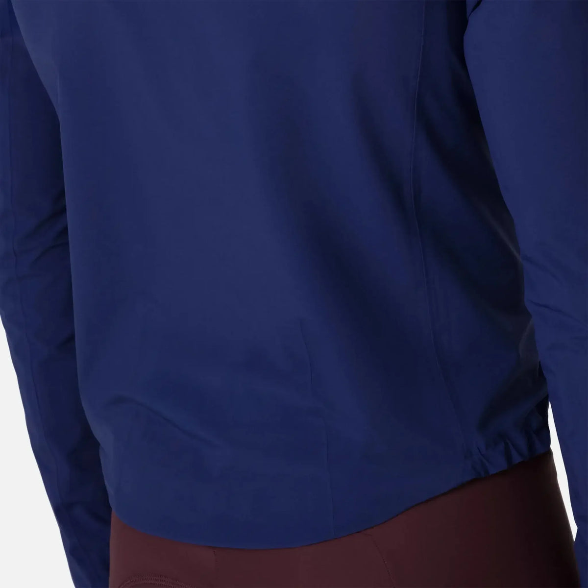 Navy blue jacket with elastic hem, paired with brown pants for outdoor wear