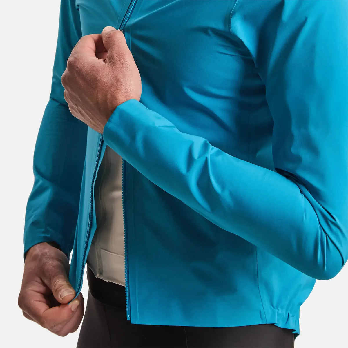 Man zipping up a vibrant blue athletic jacket for outdoor activities