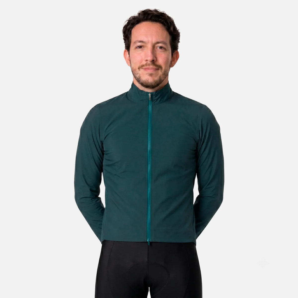 Man wearing dark green cycling jacket with full zipper and black cycling shorts