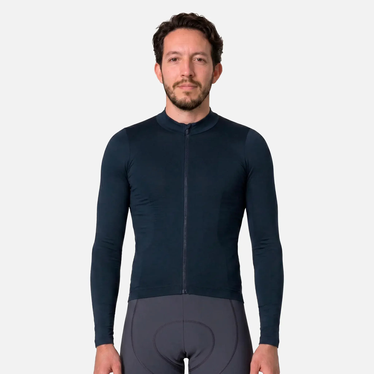Man wearing dark navy cycling jersey with full zip and matching padded shorts