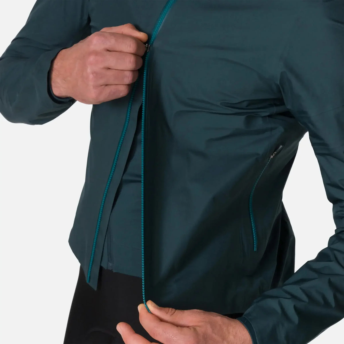 Man zipping up dark teal lightweight windbreaker jacket with contrast zipper