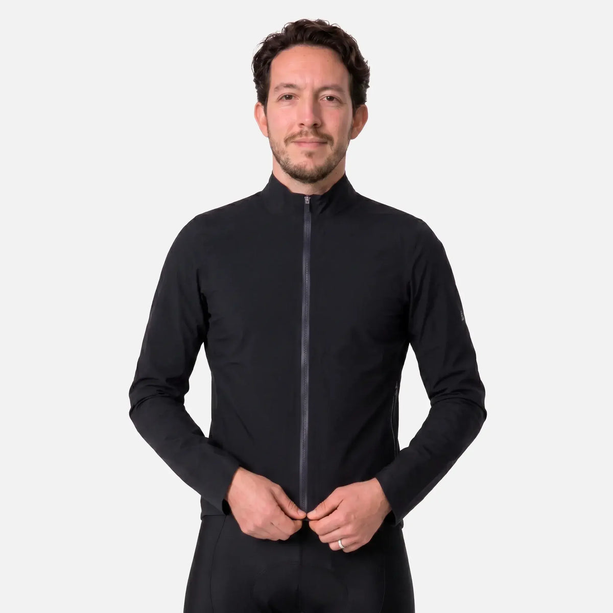 Man wearing black full-zip cycling jacket with high collar and sleek design