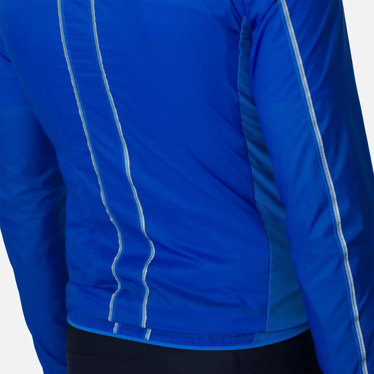 Blue athletic jacket with white seam detailing, designed for active wear and comfort.