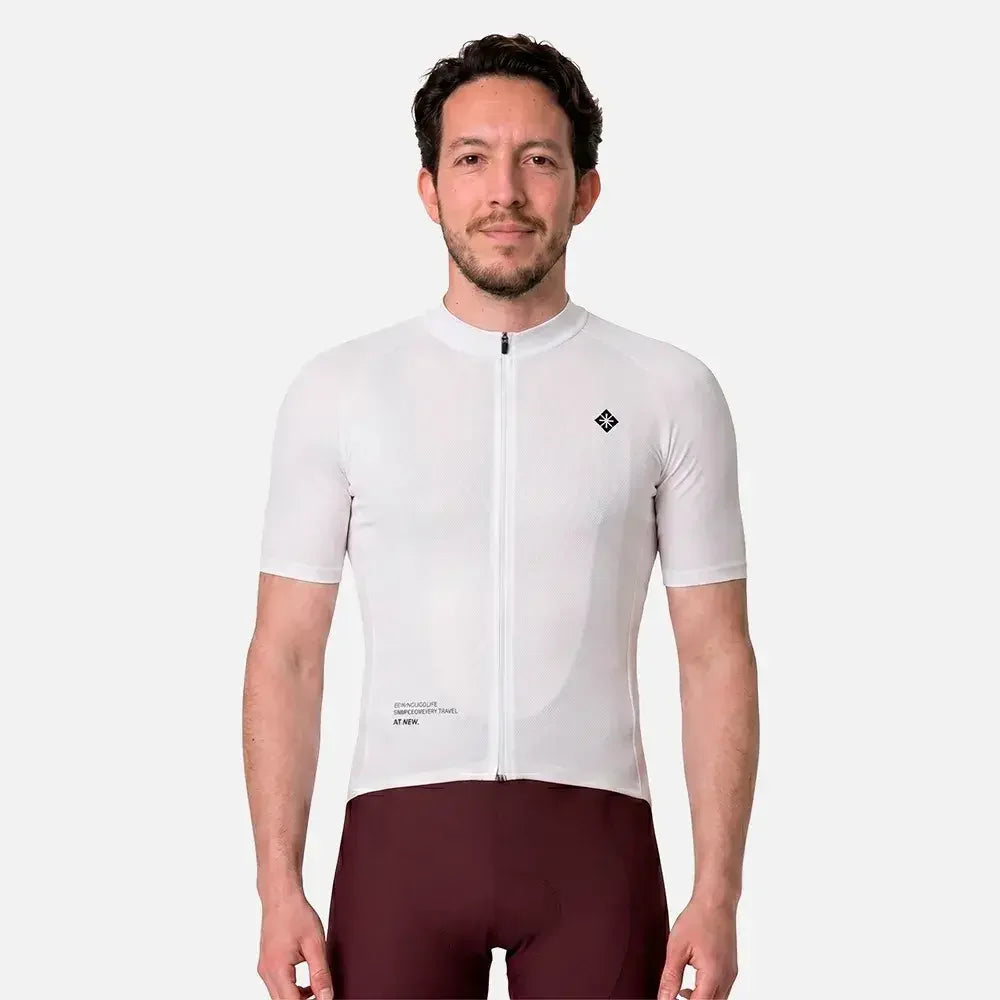 Man wearing white cycling jersey with zipper and maroon shorts, ideal for performance rides