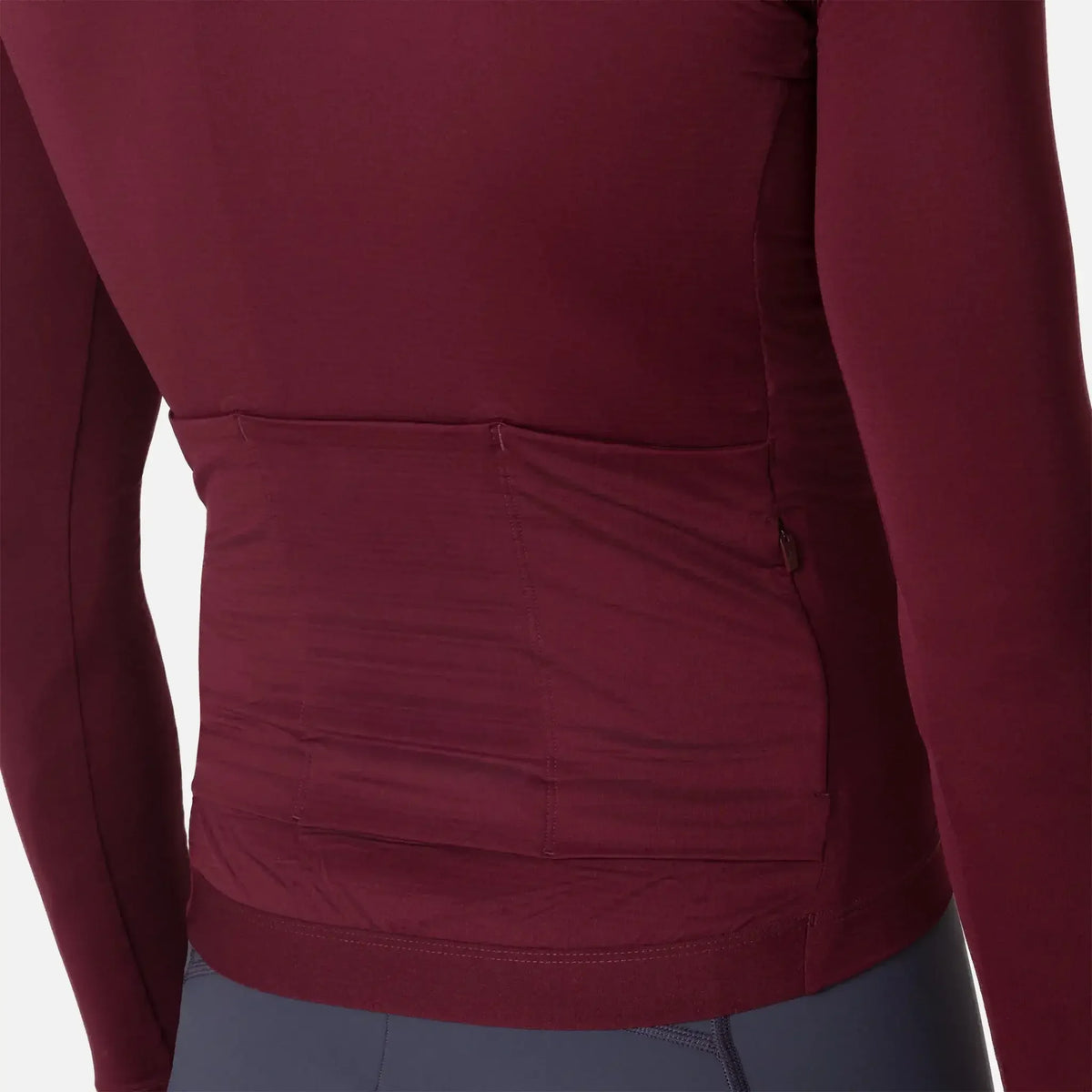 Maroon long-sleeve athletic top with back pockets and zipper detail